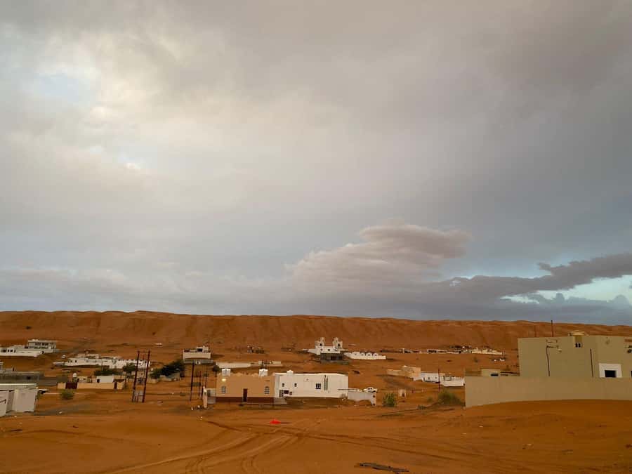 From Muscat: Wahiba Sands Sunset with Desert Camp Dinner - Camel riding across the sand