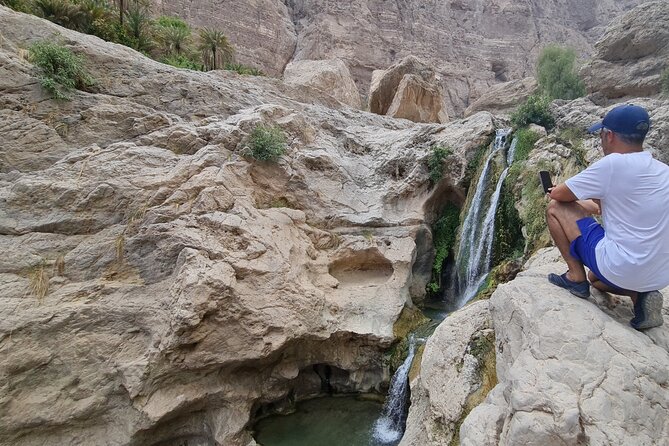 Hidden Gems of Oman: Sinkhole, Fins Beach & Wadi Tiwi Adventure - Fins Beach, white stones, and blue water
