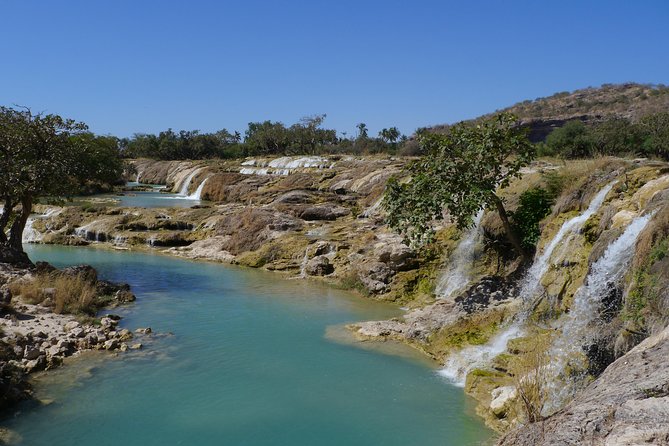 Mountain Tour - Darbat falls, Jebel Samhan, sinkholes, baobabs - Starting in Wadi Darbat with waterfalls and camels